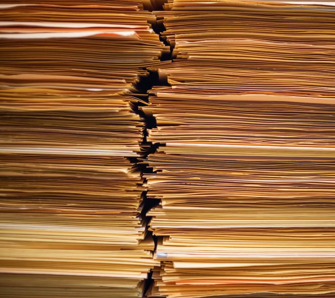 Close-up shot of an assortment of yellow folders, symbolizing detailed contract reviews and document management.